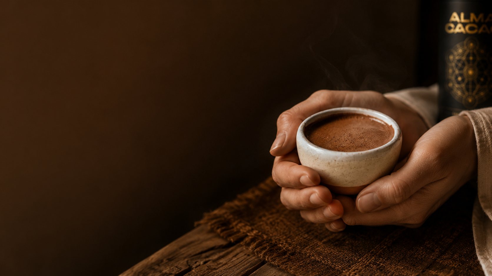 Hands cradling a warm cup of Alma ceremonial cacao